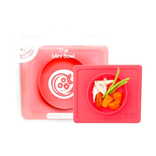 ezpz Mini Bowl for 12 Months+ (Coral) - 100% Silicone Suction Bowl with Built-in Placemat for Toddlers - Comes with a Reusable Travel Bag