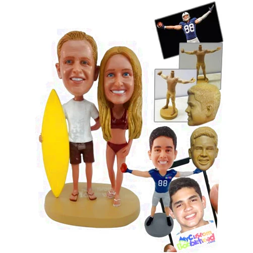 MyCustomBobblehead.com Custom Bobblehead Surfing Couple, The Man Holding A Surfboard and The Woman Dressed Appropriately Fo